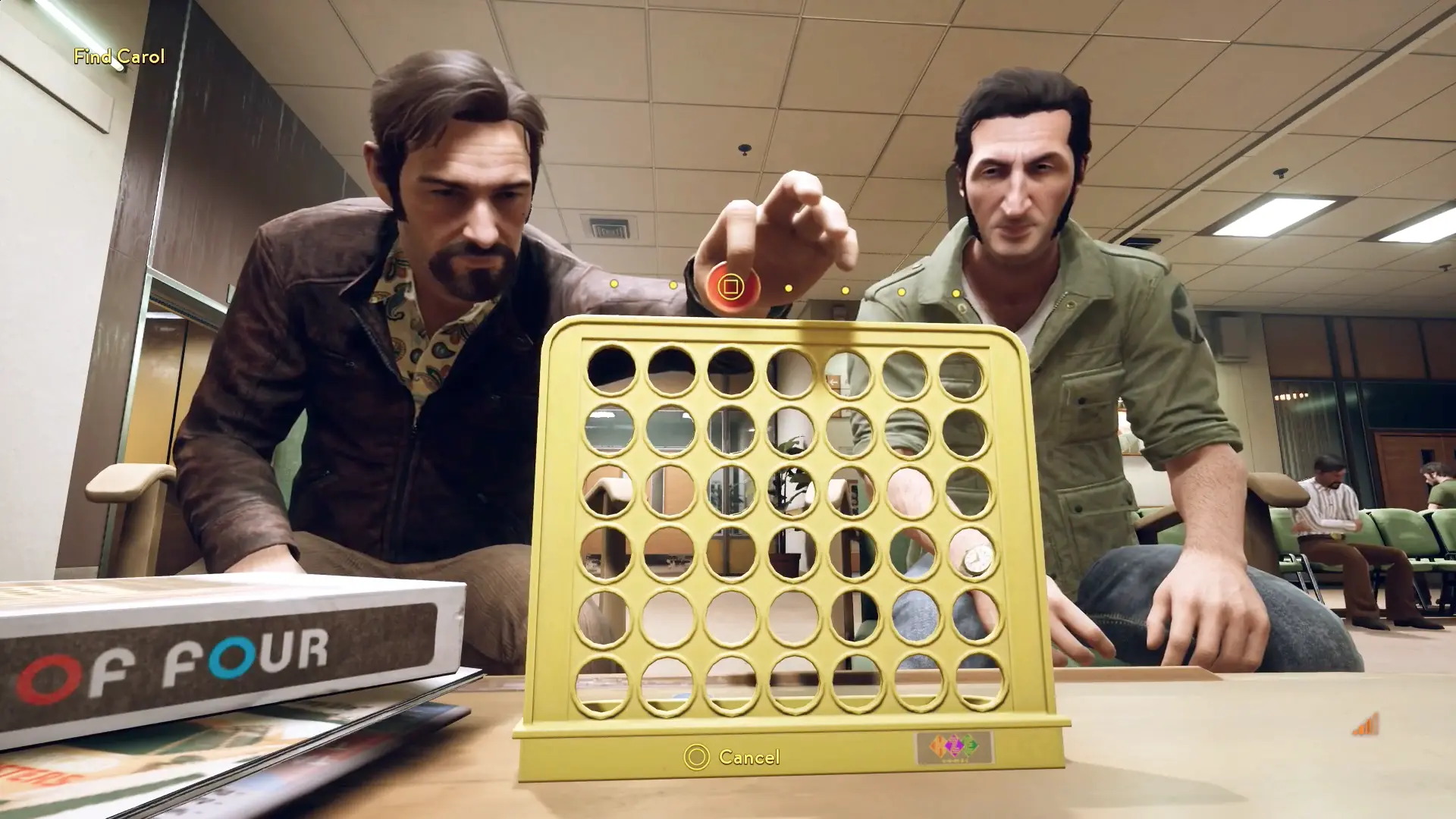 Leo and Vincent taking a break in a hospital waiting room to play a competitive game of Connect Four on a small table.