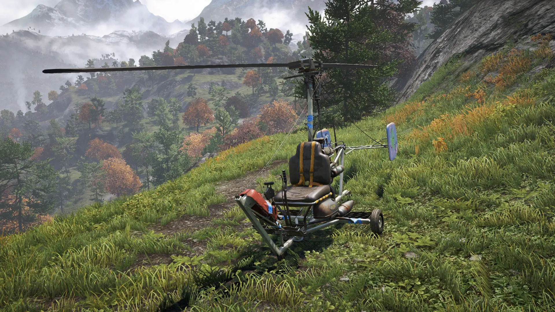 The player piloting a small, makeshift gyrocopter known as a Buzzer, flying high above the dense forests and rivers of Kyrat.