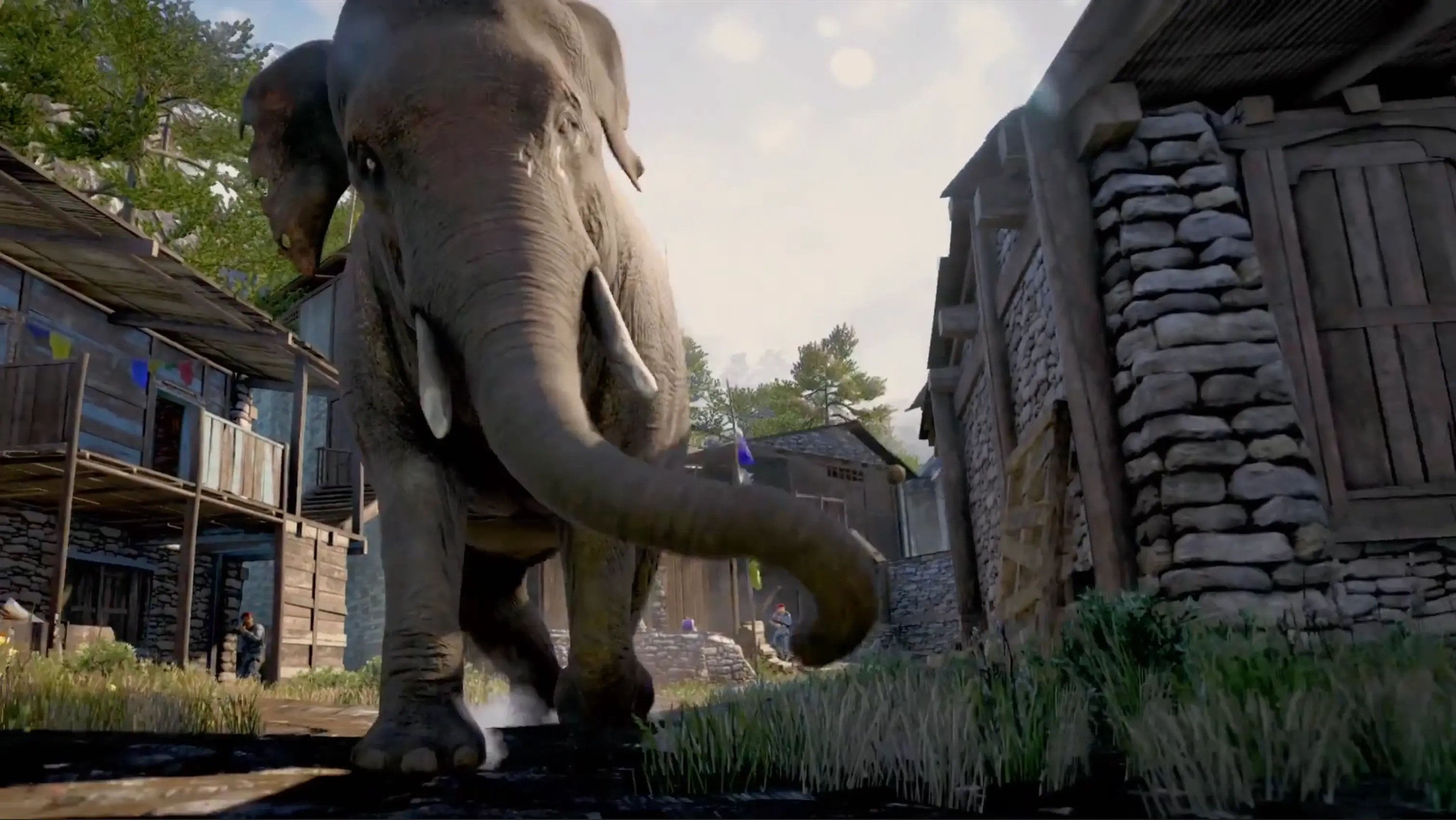 Ajay Ghale riding a massive Asian elephant, charging through the wooden gates of a Pagan Min outpost as enemies scatter in terror.