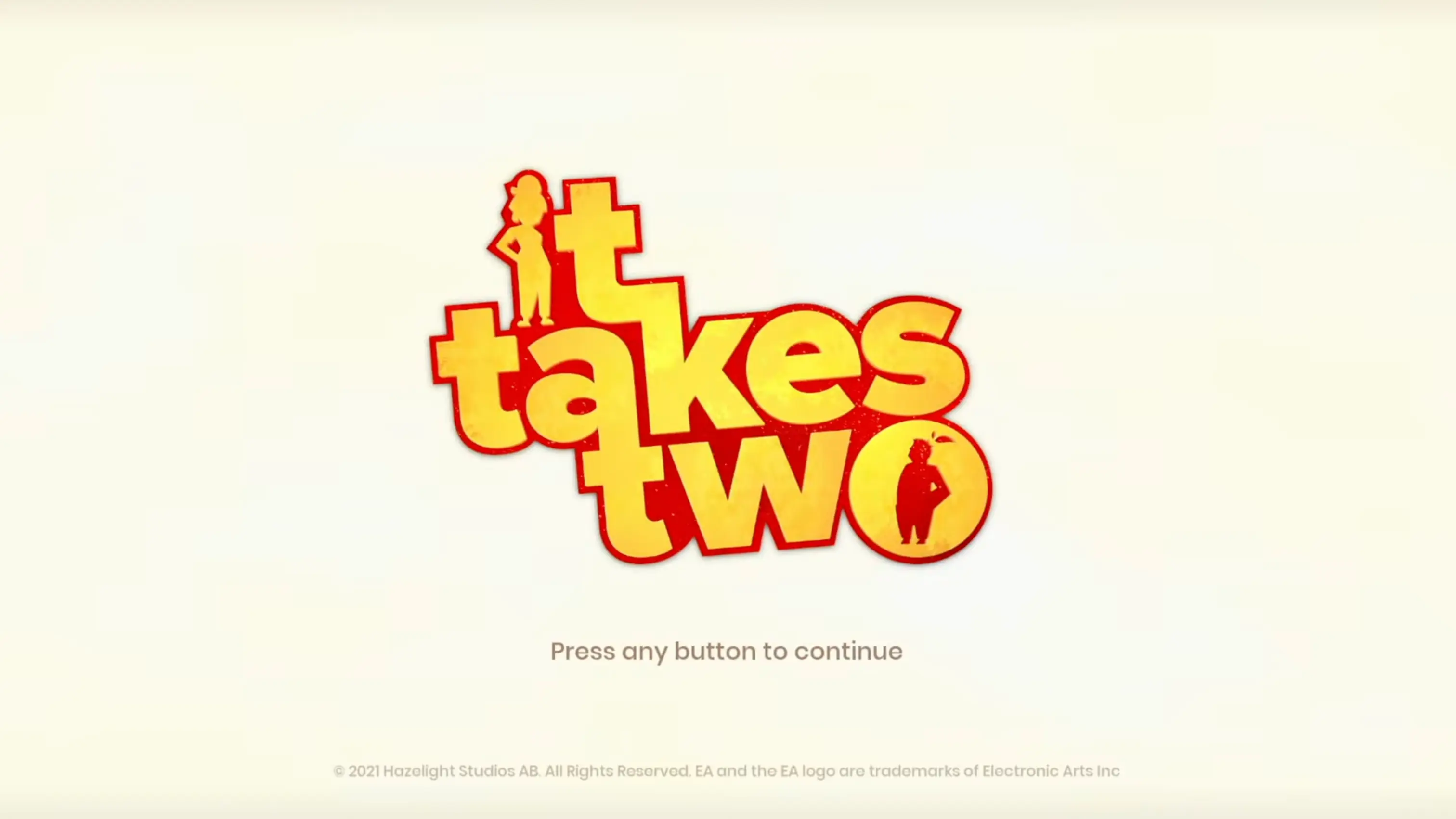 The official main menu of It Takes Two, featuring the magical Book of Love resting against a wooden backdrop with the title logo.