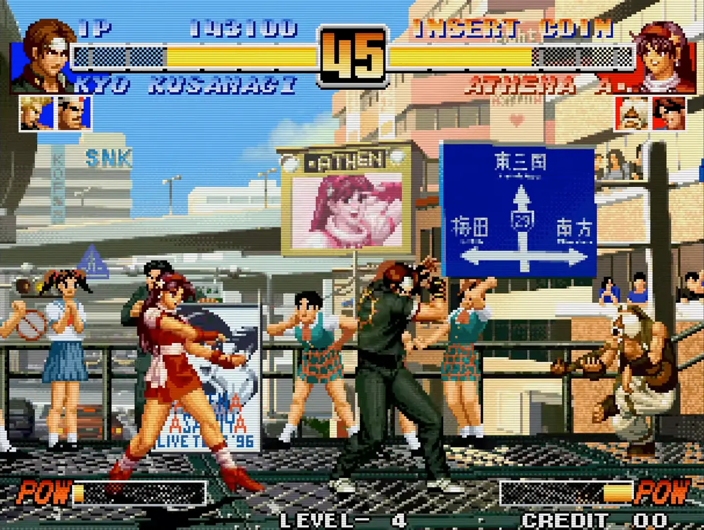 A massive, open-air tournament stadium filled with thousands of roaring spectators, flashing cameras, and giant corporate sponsor banners framing the fight.