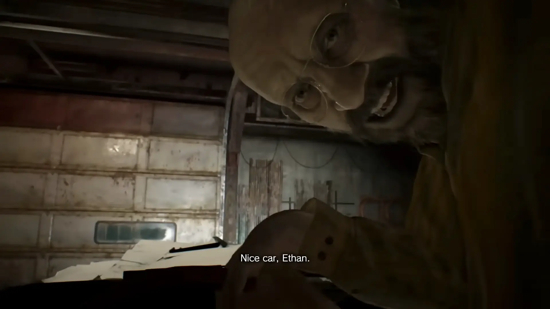 The boss fight in the garage: Ethan at the wheel of the car while a laughing Jack Baker hitches a ride on the hood.