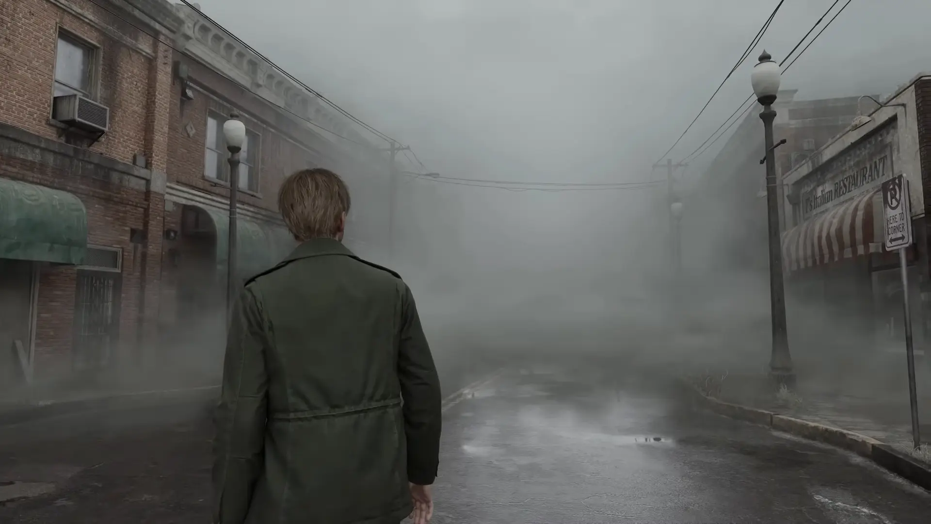 The iconic view of the Silent Hill streets, blanketed in thick, volumetric fog that realistically obscures the town's rotting architecture.
