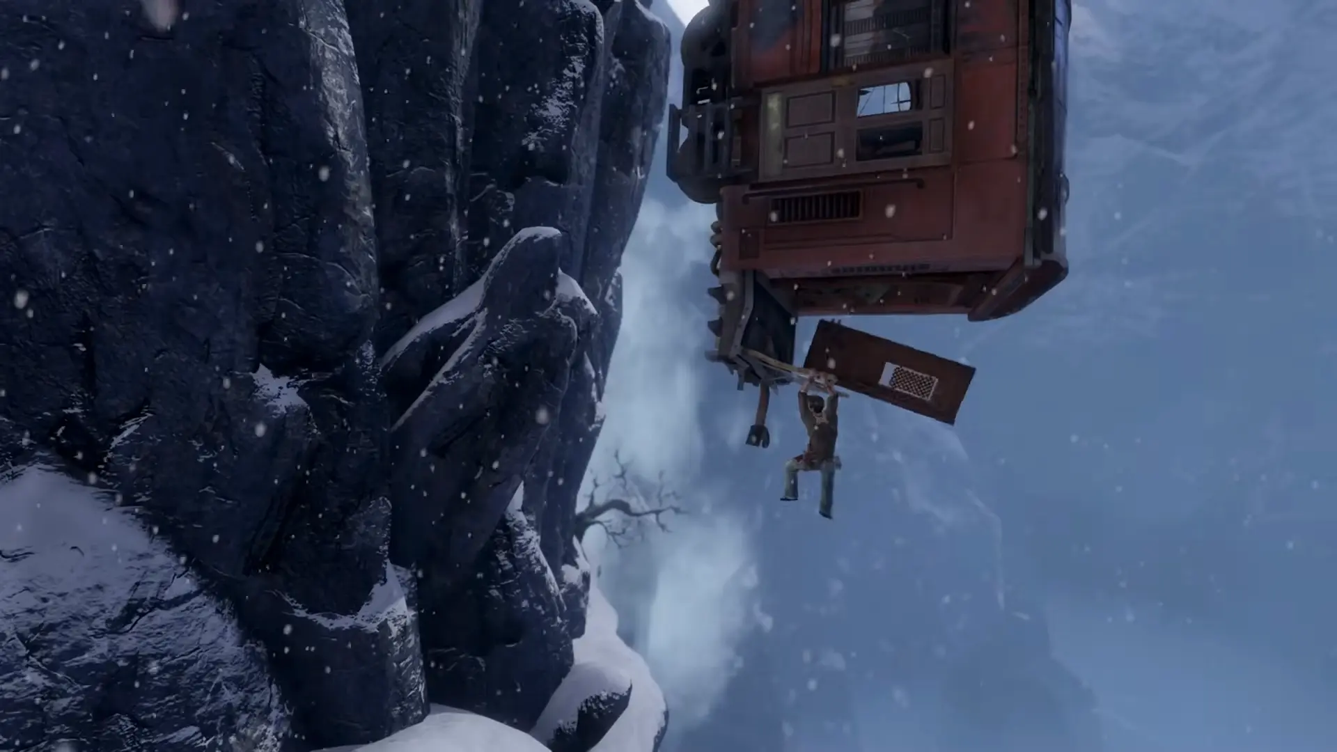 Nathan Drake hanging from a dangling train car in the snowy mountains.