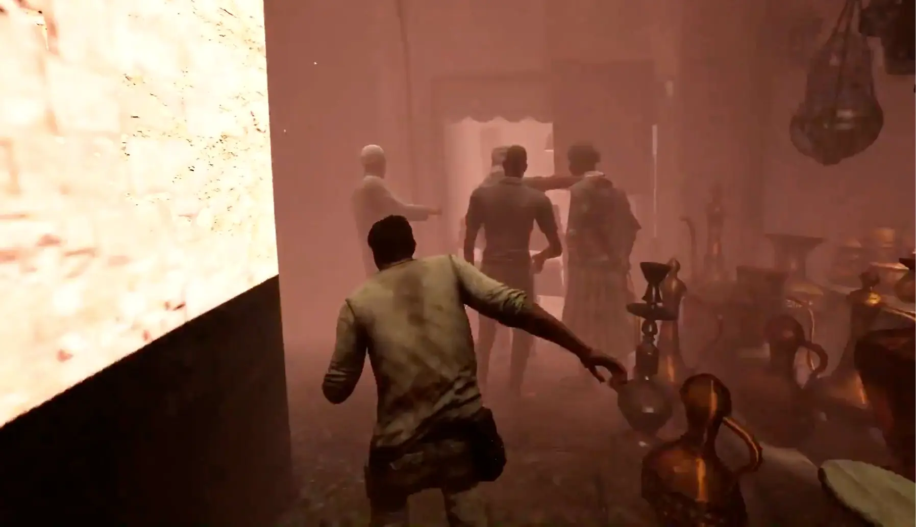 Nathan Drake struggling through a sandstorm while suffering from hallucinations.