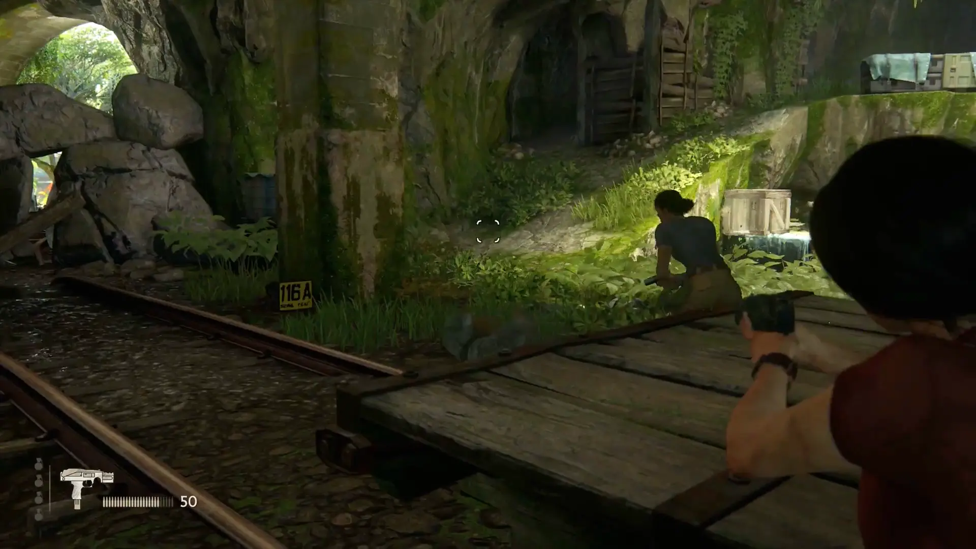 Chloe using the silenced pistol to take down an insurgent silently from the shadows.