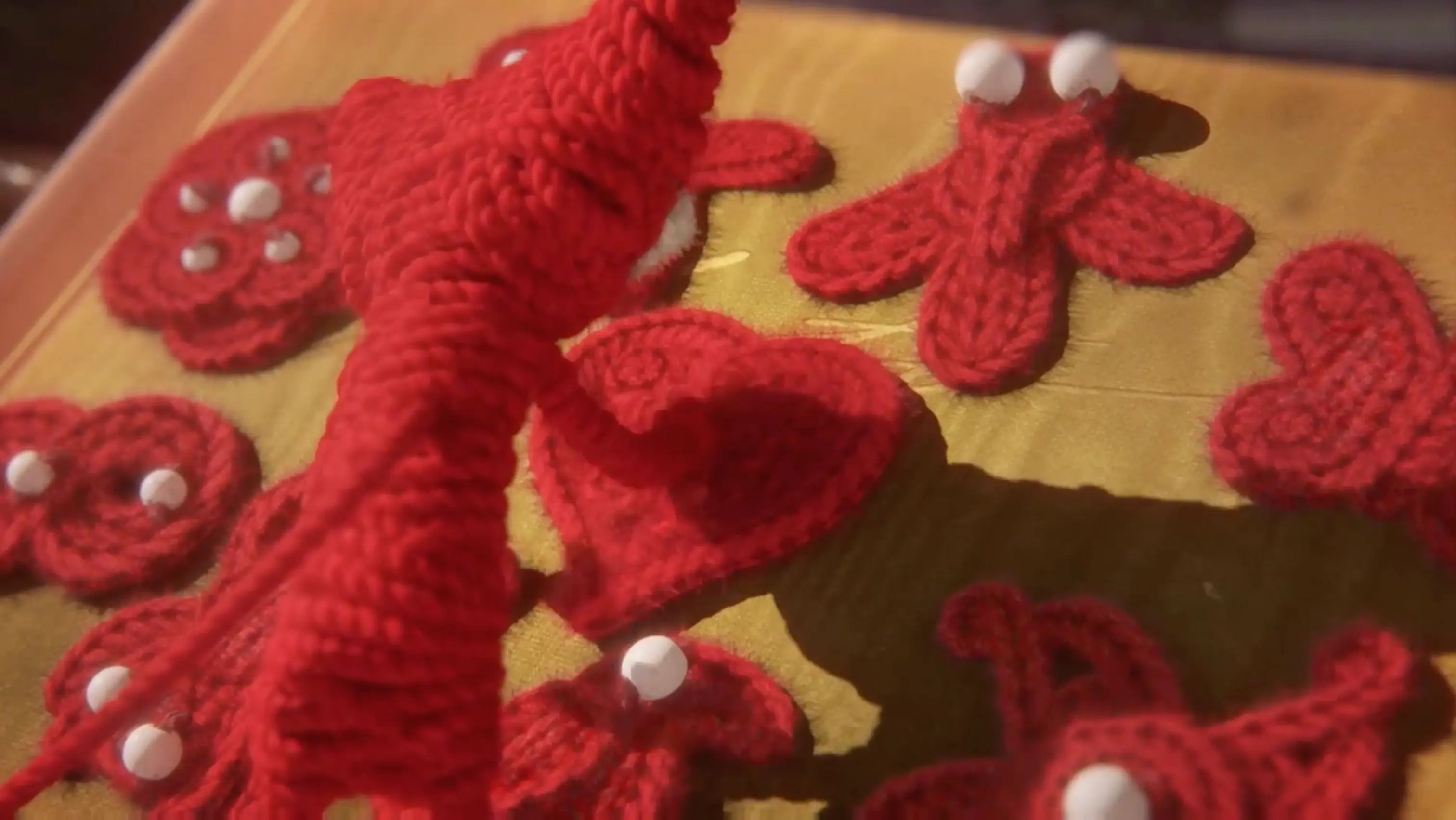 Yarny warmly hugging the yarn badge at the end of his difficult journey.